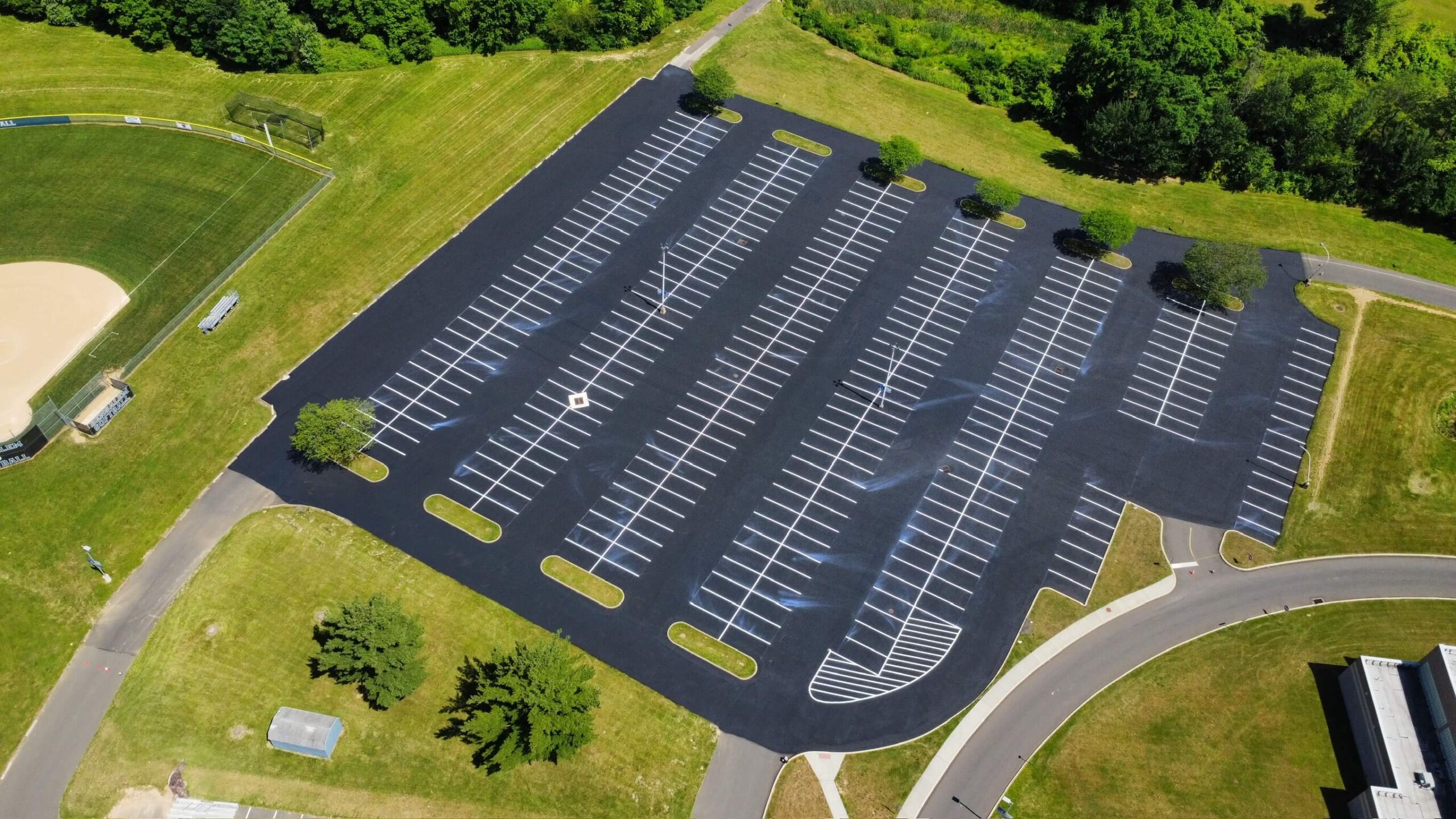 Crack sealing in progress on Bensalem High School asphalt parking lot