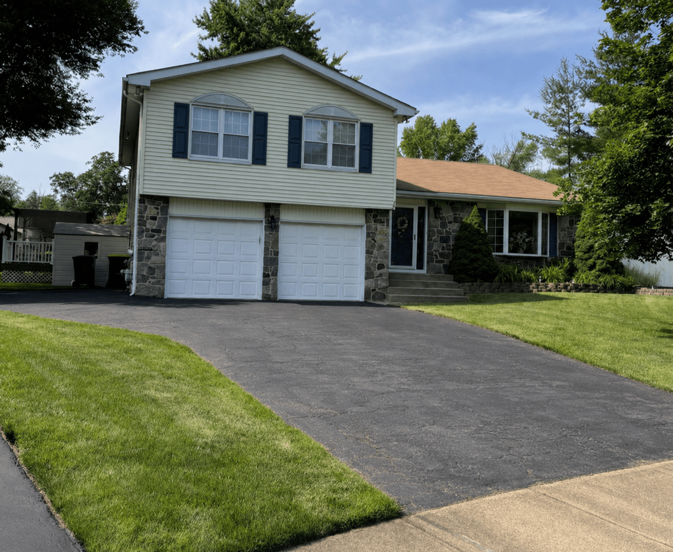 Before sealcoating — faded cracked driveway Doylestown PA